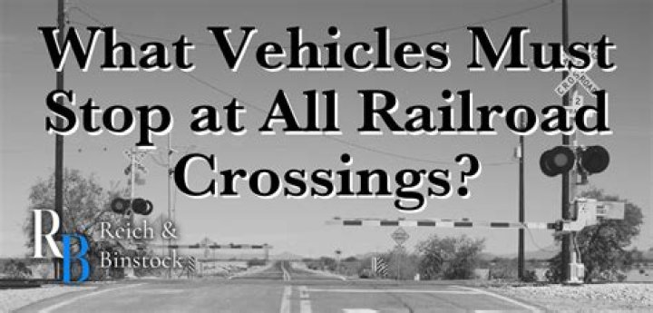 Which vehicle must always stop before crossing railroad tracks?